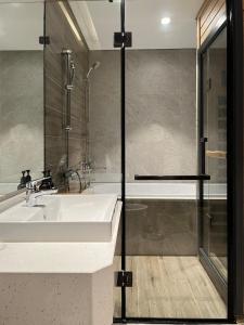a bathroom with a sink and a shower at Mizu Room Ecopark panorama view in Kim Quan