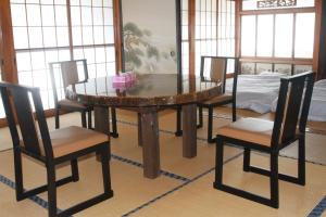 a dining room table with four chairs and a bed at Oshu - House - Vacation STAY 19753 in Hiraizumi