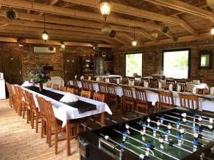 a dining room with a pool table and chairs at Piros Tanya és Vendégház in Nyíregyháza