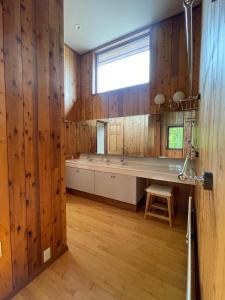 a kitchen with wood paneled walls and a window at The Lakehouse at Toyako - Vacation STAY 44256v in Tōya