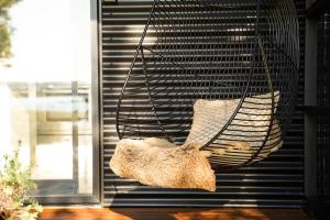 a teddy bear sitting in a hanging swing at Hightide River Escape -with Outdoor Bath in Hokitika