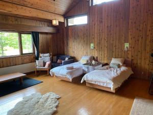 a bedroom with two beds and a couch in it at The Lakehouse at Toyako - Vacation STAY 44250v in Tōya