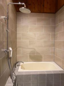 a bath tub in a bathroom with a shower at The Lakehouse at Toyako - Vacation STAY 44250v in Tōya