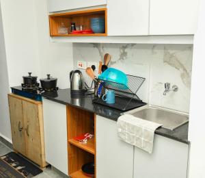 a kitchen with a counter top with a sink at comfystdkiambu in Kiambu