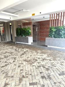 a lobby with two potted plants in a building at comfystdkiambu in Kiambu