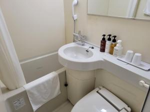 a small bathroom with a sink and a toilet at Smile Hotel Osaka Tennoji - Vacation STAY 41030v in Osaka