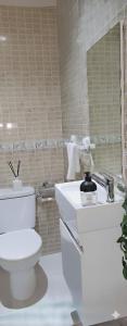 a bathroom with a toilet and a sink and a mirror at Iris appartement salé rabat in Sale