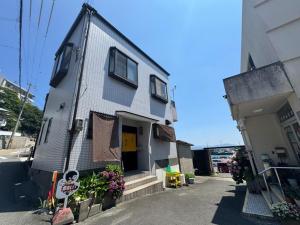a gray house with clothes hanging on the side of it at Namihaya Inn Hanon - Vacation STAY 69722v in Dejima