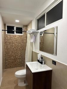 a bathroom with a sink and a toilet and a shower at Agenda Hotel in San Salvador