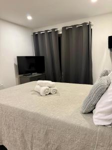 a bedroom with a bed with two towels on it at Manu Double Room in London +40 photos
