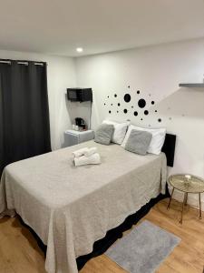 a bedroom with a large bed with two towels on it at Manu Double Room in London