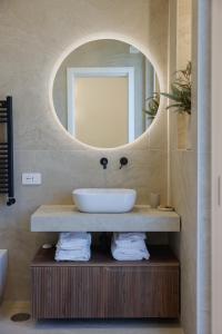 a bathroom with a sink and a mirror at SOFIA Suites & Rooms in Pompei