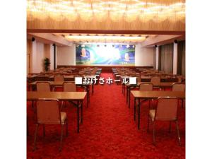 a large room with tables and chairs and a stage at Yahatakan - Vacation STAY 32424v in Sado