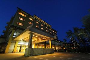 a building with a sculpture in front of it at night at Yahatakan - Vacation STAY 32424v in Sado