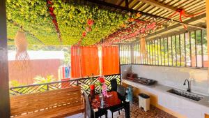 a room with a bunch of flowers hanging from a ceiling at Chateau La Princesa with cozy garden & bar in Puerto Princesa City
