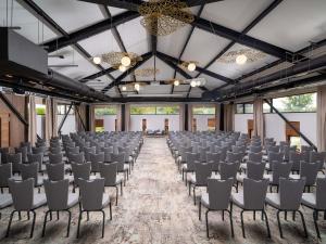an empty hall with rows of chairs in a room at Mercure Conacul Cozieni in Bucharest +75 photos