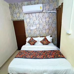 a bed with two pillows on it in a room at SR Elite Stays in Jaipur +2 photos
