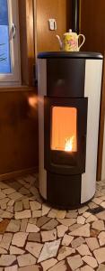 a stove in a room with a fire in it at Appartamento " Le Farfalle " in Santorso