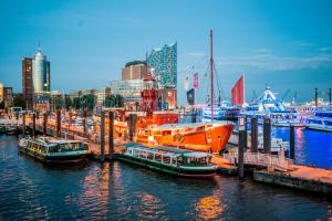 a group of boats docked at a dock in a city at Das Feuerschiff in Hamburg