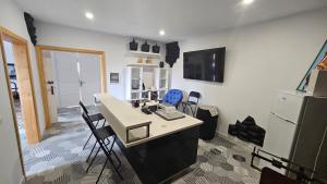 a room with a desk with chairs and a refrigerator at Casa Daniela in Tacoronte +8 photos