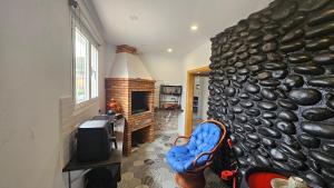 a living room with a stone wall and a fireplace at Casa Daniela in Tacoronte