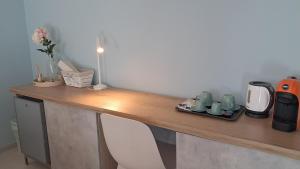 a wooden counter with a coffee maker and cups on it at Il Nocciolo in Gaiola