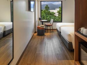 Postel nebo postele na pokoji v ubytování ibis Chiang Mai Nimman Journeyhub