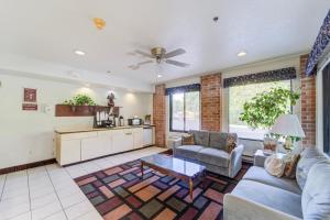 a living room with a couch and a table at Capital O Amerihost Inn and Suites Fulton Hwy 54 MO in Fulton
