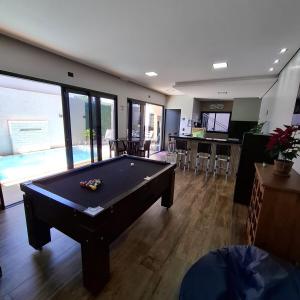 a billiard room with a pool table in the middle at Casa para Temporada - Espaço Vip Hall in Cascavel