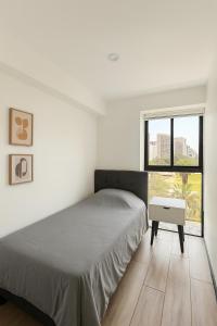 Ένα ή περισσότερα κρεβάτια σε δωμάτιο στο Cozy 3BR Nice View in Barranco