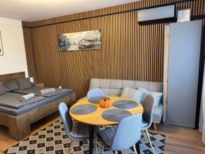 a living room with a table and a couch at Mini Premium in Miskolc
