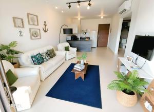 a living room with a white couch and a blue rug at Salty Life Chalet, Azha in Ain Sokhna