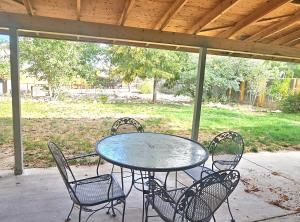 a table and chairs sitting on a patio at Spacious home away from home! in Pueblo