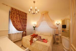 Postel nebo postele na pokoji v ubytování Hotel Astigiana & Appartamenti + 37 fotografií
