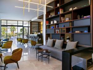a living room with a couch and chairs at Mercure Larnaca Beach Resort in Larnaka
