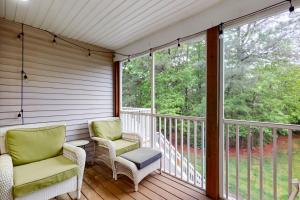 a screened in porch with two chairs and windows at Sea Colony - 56119 Cypress Lake Cir in Bethany Beach