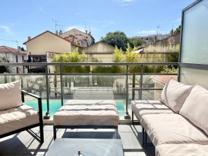 a balcony with two beds and a swimming pool at T2 - piscine - garage privé - 5 min de Cannes in Le Cannet