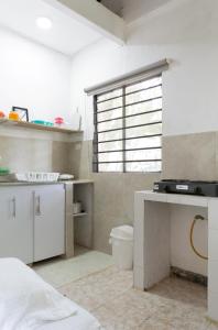 a bathroom with a sink and a toilet in a room at Hotel Villa Ivel in Turbaco