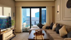 a living room with a couch and a television at واحة ايلة ازور in Aqaba