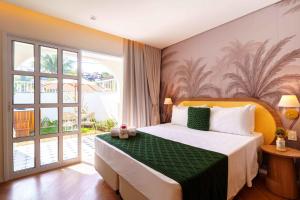 a bedroom with a bed and a large window at Santé Vivre L'Experience by Livá OFICIAL in Búzios +25 photos