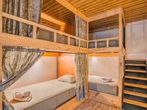 a bedroom with two bunk beds in a cabin at Koru Boutique Hostel Uvita in Uvita
