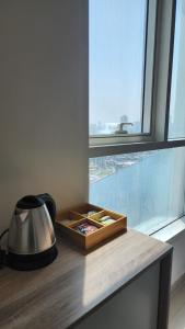a wooden counter top with a tray and a window at Waterfront apartment with a breathtaking view in Sharjah