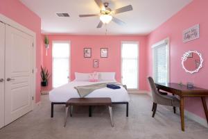 a pink bedroom with a bed and a desk at Lipstick & Boots 10 min to Broadway, Music Row, Fun in Nashville