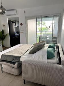 a bedroom with a bed and a couch in it at Casa Montebello in Petit-Bourg +11 photos