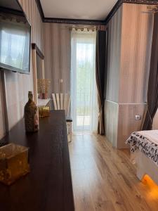 a bedroom with a table and a bed and a window at Pirin Elegance Apartment by Gondola Lift in Bansko