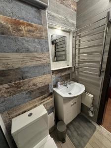 a bathroom with a white toilet and a sink at Pirin Elegance Apartment by Gondola Lift in Bansko
