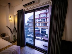 a bedroom with a window with a view of a building at Premium Studio Apartment, East Legon in Accra