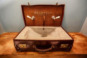 a piece of luggage sitting on top of a wooden table at Backwell House in Nailsea