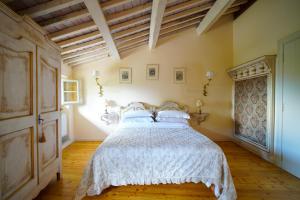 a bedroom with a bed with a white bedspread at Villa Dorigny Dimora Storica con Affreschi e Giardino in Verona +73 photos