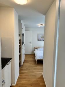 a hallway leading to a bedroom with a bed at Mc Solutions Apartment im Zentrum in St. Gallen